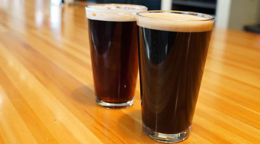 Image of two pint glasses, on the right is Northern Brewer's Dry Irish Stout and on the left is Northern Brewer's Irish Red Ale - both on nitro.