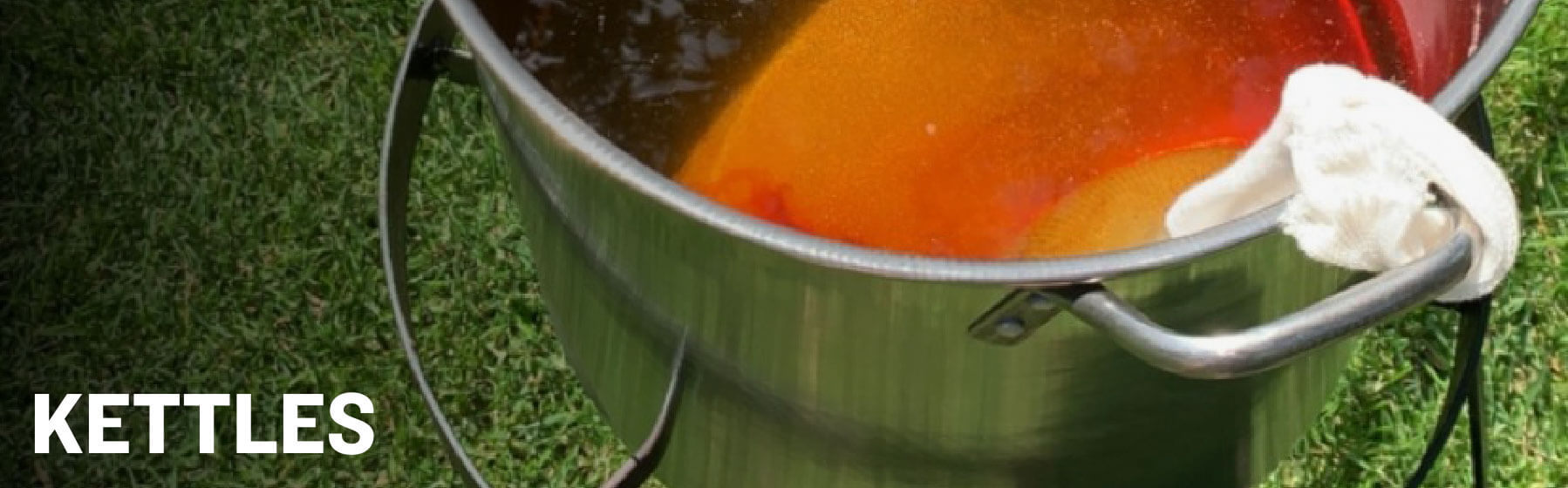 Image of a kettle with wort in grass with the word Kettle on top
