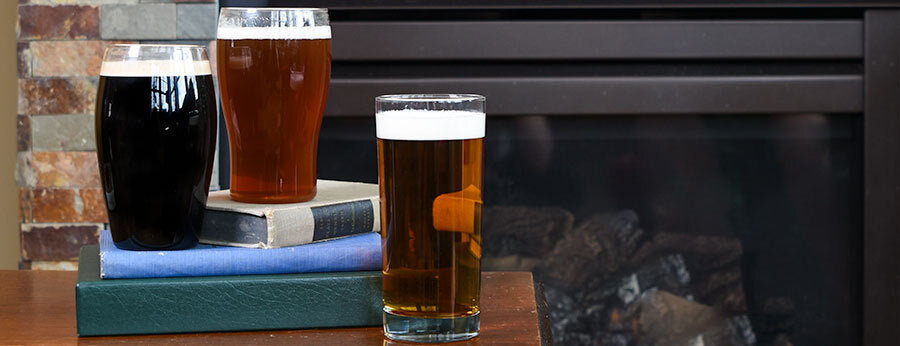 Glasses of Dry Irish Stout, Irish Red Ale, Irish Blonde Ale on wooden bench