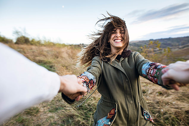 woman excited and happy, playing in an open field