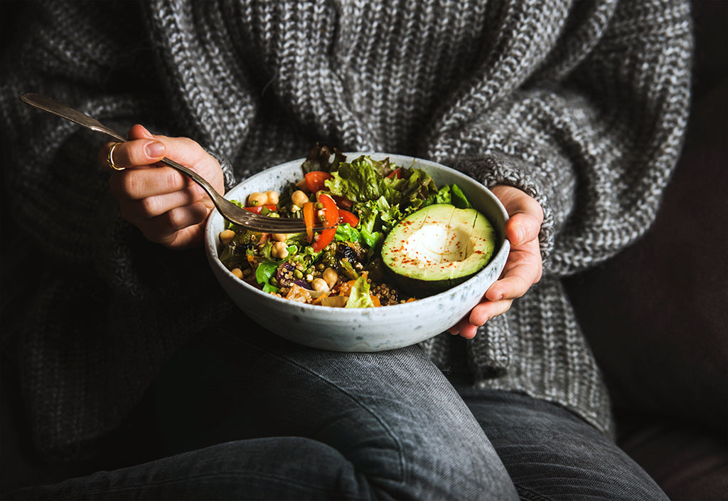 woman eating fresh salad - avocado beans and vegetables - nutrients