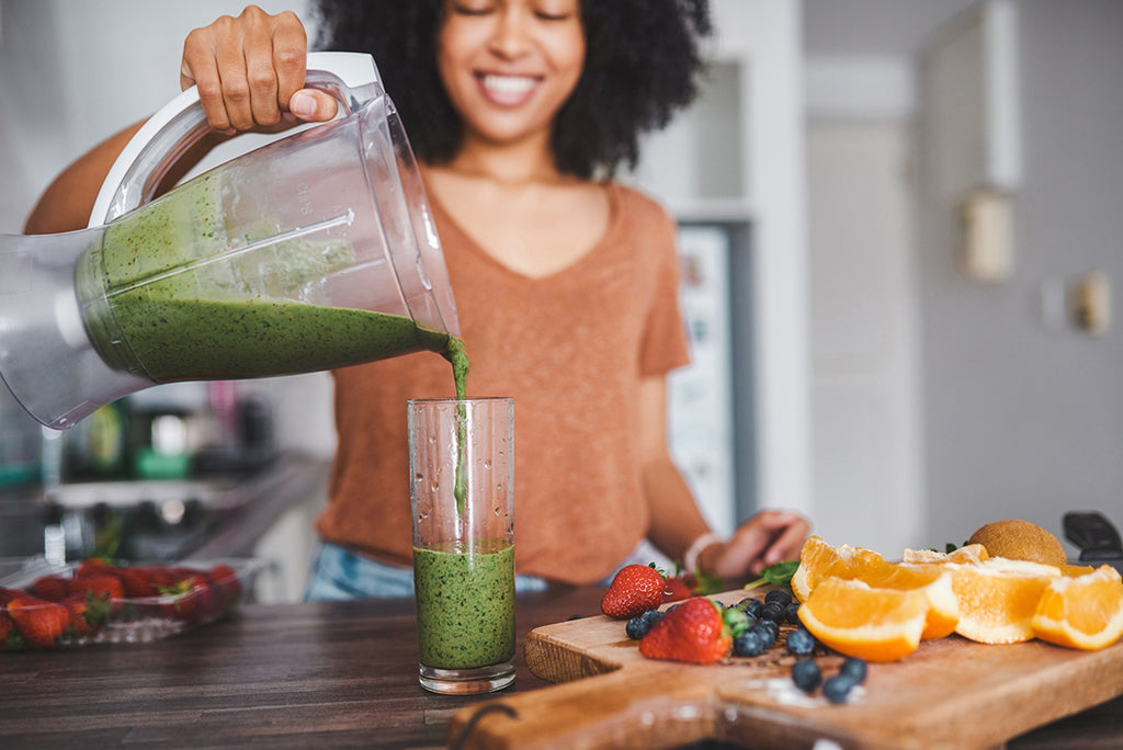 woman pouring a green smoothie  - nutritional foundation