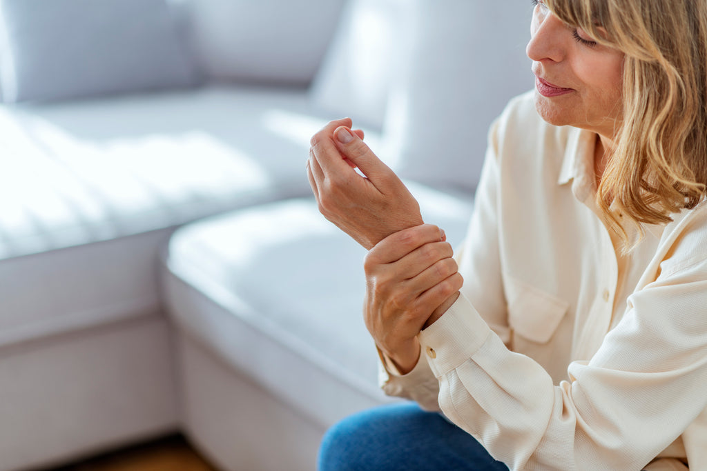 woman holding wrist with arthritis pain