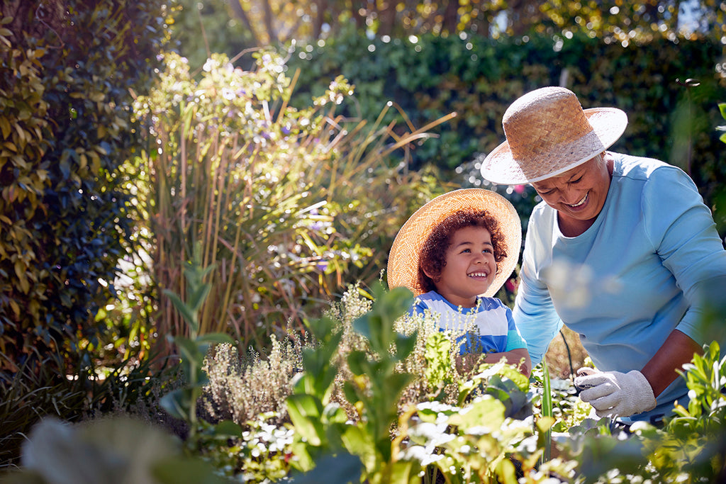 grandma and child gardening outdoors - spring allergy relief