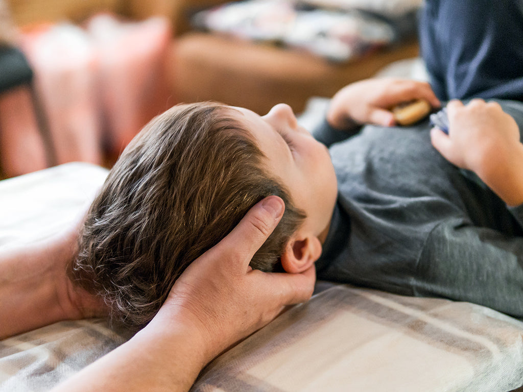 boy getting a chiropractic adjustment for seasonal spring allergy relief