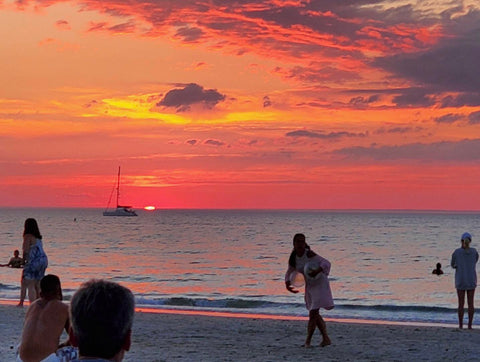 mayflower beach dennis ma sunset with people playing on the beach