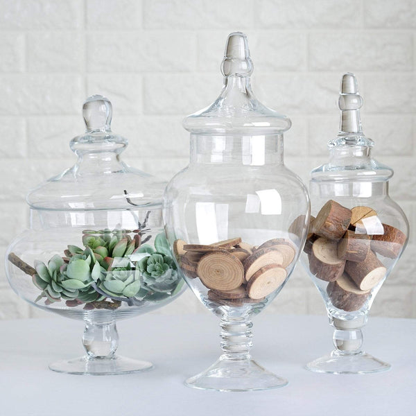 https://cdn.shopify.com/s/files/1/2789/7936/products/balsa-circle-favors-3-pcs-10-12-14-tall-clear-glass-apothecary-jars-with-lids-glas-jar12-clr-6985297068080_600x600.jpg?v=1630250707