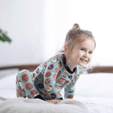 a child wearing bamboo pajamas featuring bagels
