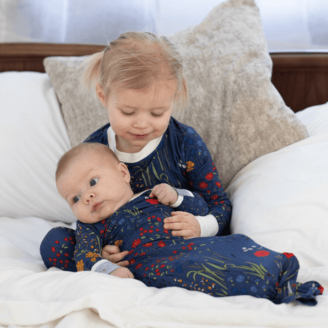 a baby and big sister in matching bamboo pajamas