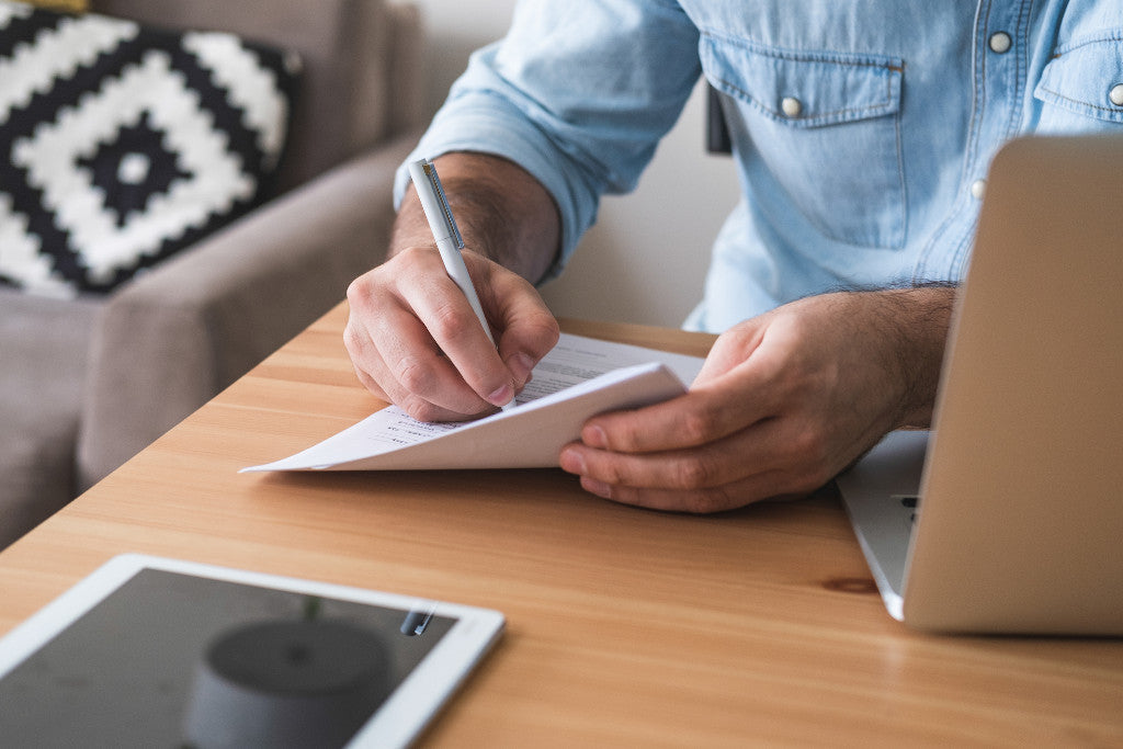 Man writing down positive affirmations