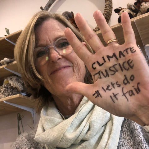 Bron smiling with 'climate justice, #lets do it fair' written on her hand