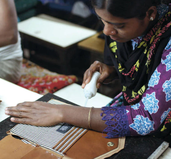 O My Bag Artisans - STC Factory India. A woman hand crafts a leather bag.