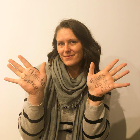 Bec K with 'climate justice #lets do it fair' written on her hands