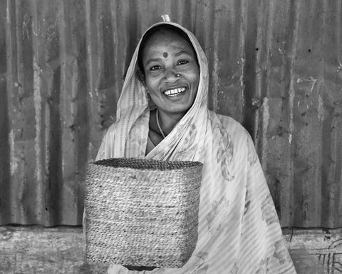 The Dharma Door artisan in Bangladesh holding basket