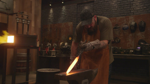 TYLER HACKBARTH checks how his billet is shaping together on Round One of the Battle of the Branches Tournament: Army on HISTORY’s “Forged In Fire” airing Wednesday, May 8 at 9PM ET/PT. Photo Credit: HISTORY