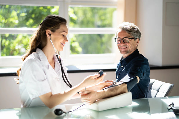 Doctor Measuring Blood Pressure Of Patient