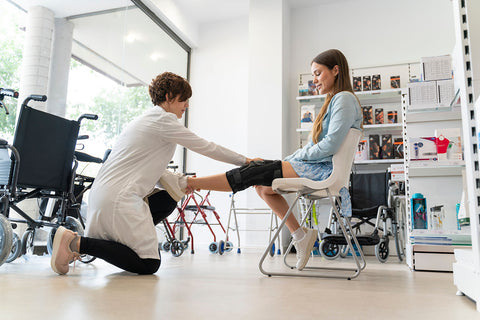 A woman recovering from surgery goes to an orthopedic physical therapy appointment for rehabilitation.