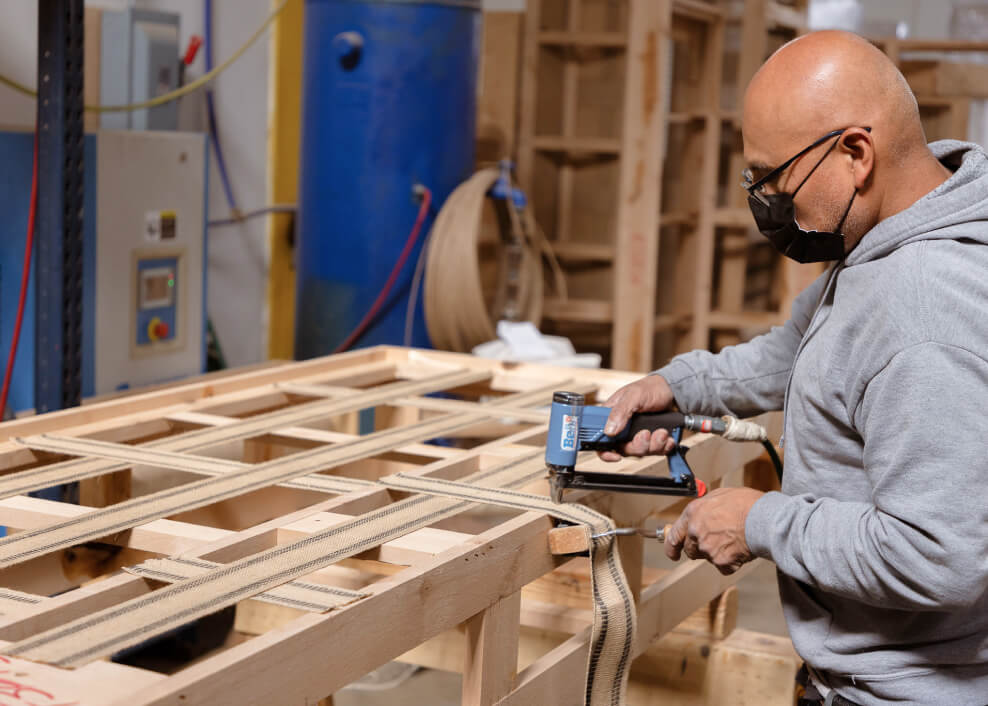 medley worker installing webbing onto a frame