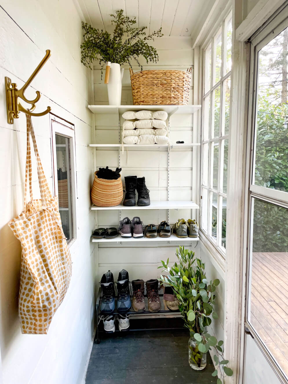 White mudroom with shoe rack