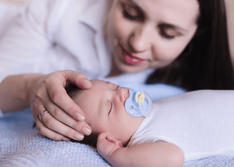 mother stroking her baby's head