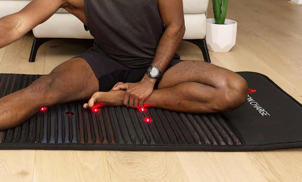 Man stretching on a PEMF mat