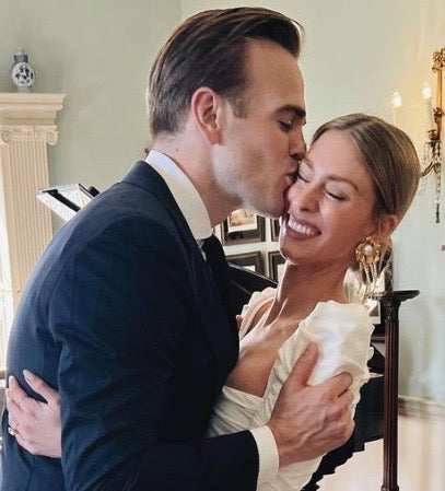 Groom kissing Lauren on the cheek.