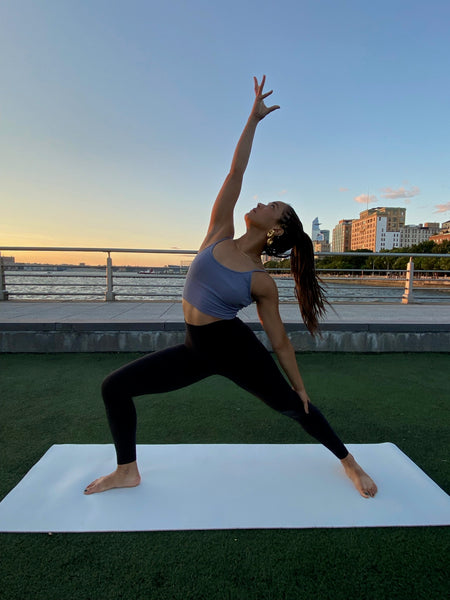 Mikayla outside doing yoga 