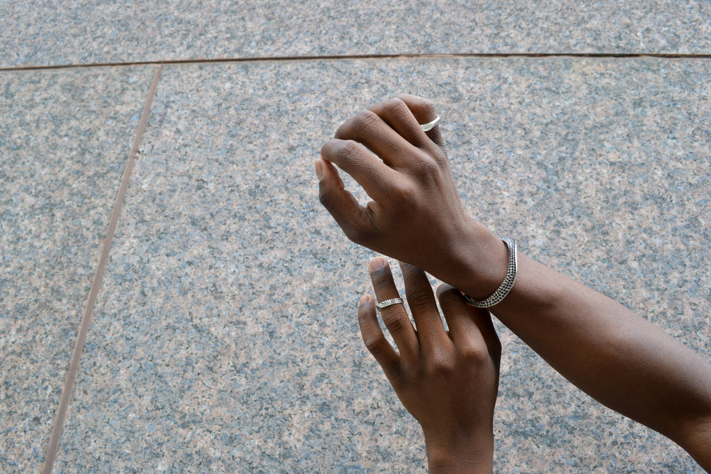 Isaiah's hands with Ridge rings and Ridge Cuff on 