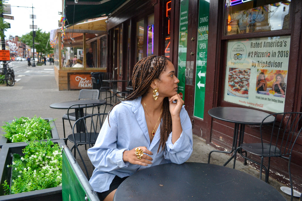 Mikayla sitting outside of Bleecker Street Pizza