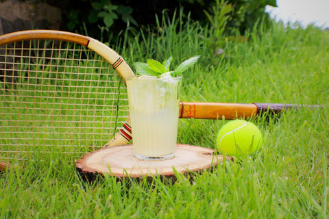 Perfect serve cocktail styled with old tennis racket