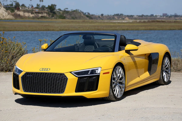 Yellow Audi R8 convertible with top down 