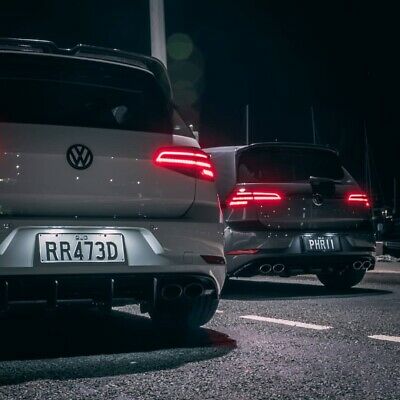 Mk7 GTI rear view image of 2 GTI's with lights on in the dark