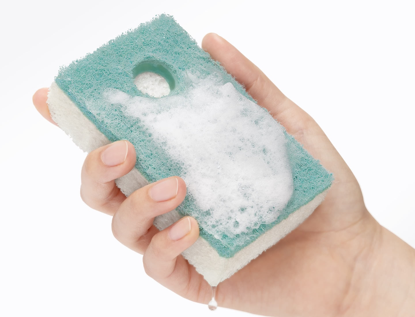 hand holding natural sponge with soap bubbles