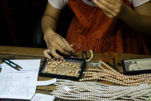jeweler stringing beads
