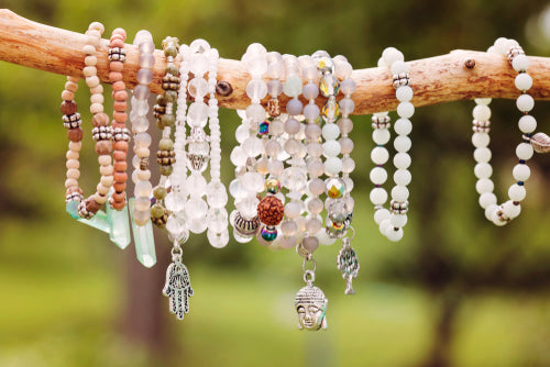 natural bead bracelets hanging from branch