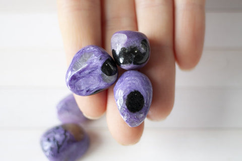 charoite stones with black spots