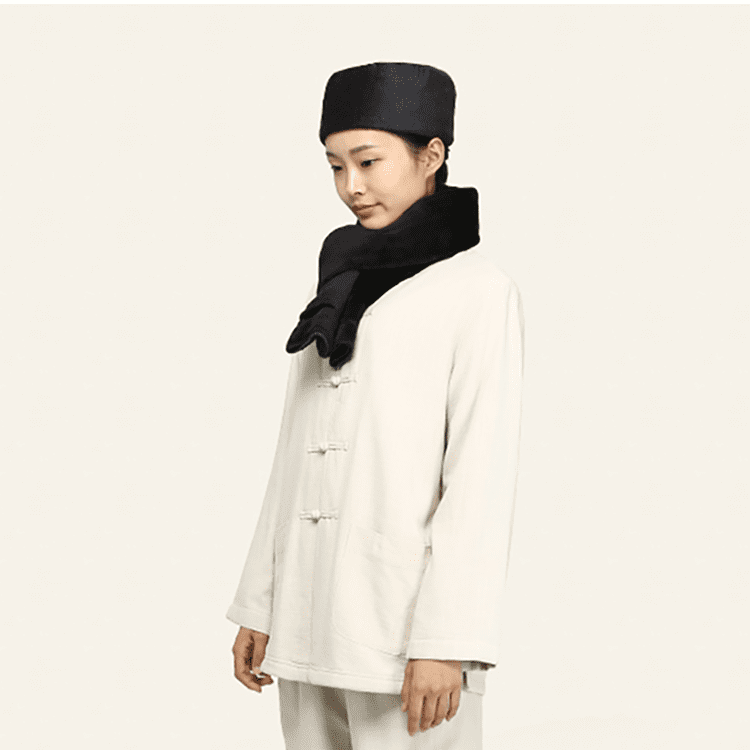 A woman with a dark grey Shaolin monk hat