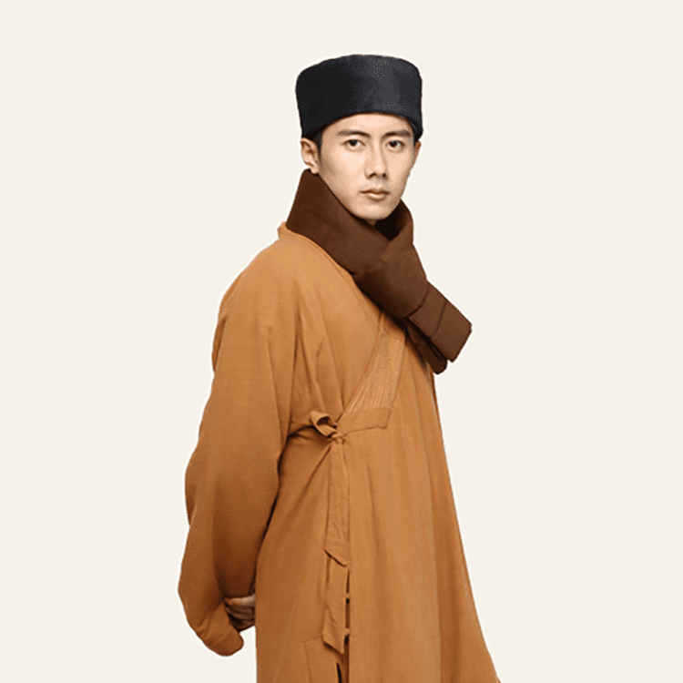 A man with a dark grey Shaolin monk hat