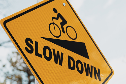 Road sign with words ‘’slow down’’