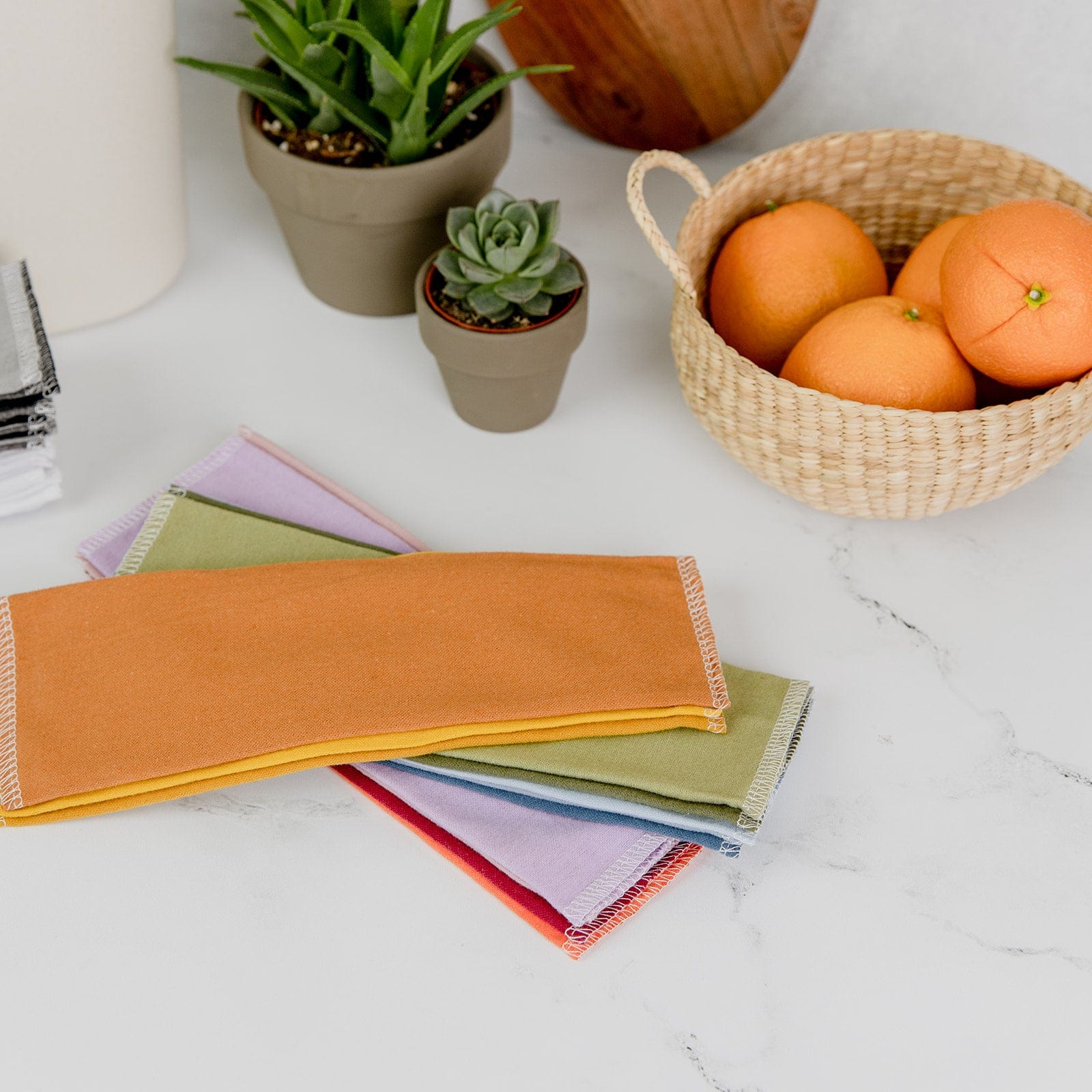 roll of unpaper towels with lemon print on white kitchen countertop in papertowel holder.