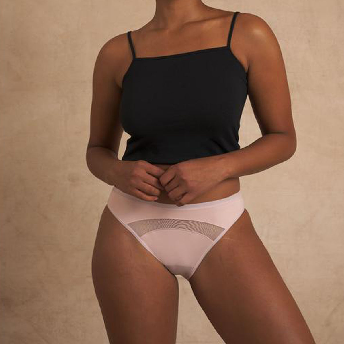 Woman wearing pink mesh reusable period undies