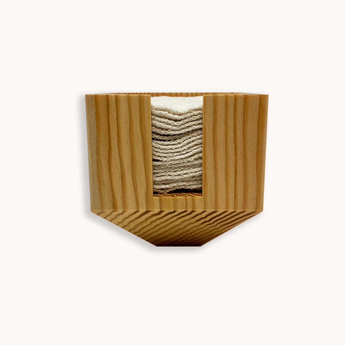 A stack of reusable cotton rounds stacked inside a bamboo storage container.