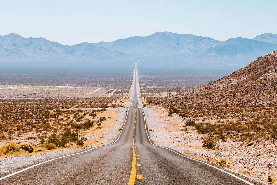 Long highway stretching into the mountains