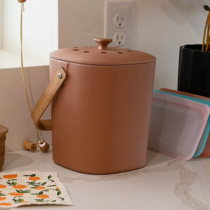 Small terracotta color bin on a kitchen counter top