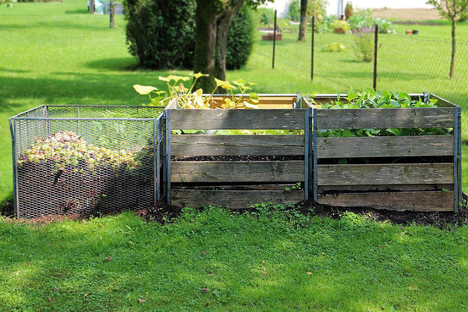 compost bins in a green yard