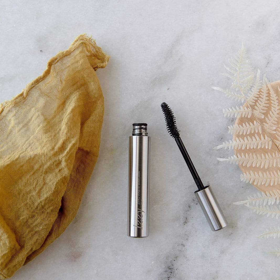 Stainless Steel mascara upright tube and upside down wand side by side. Tube reads: Izzy: Zero Waste Mascara BLK