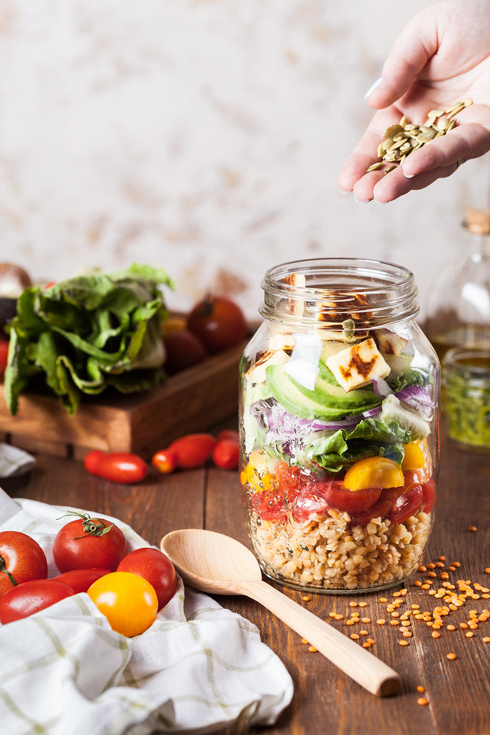 A jar containing the ingredients for a salad stacked on top of each other.