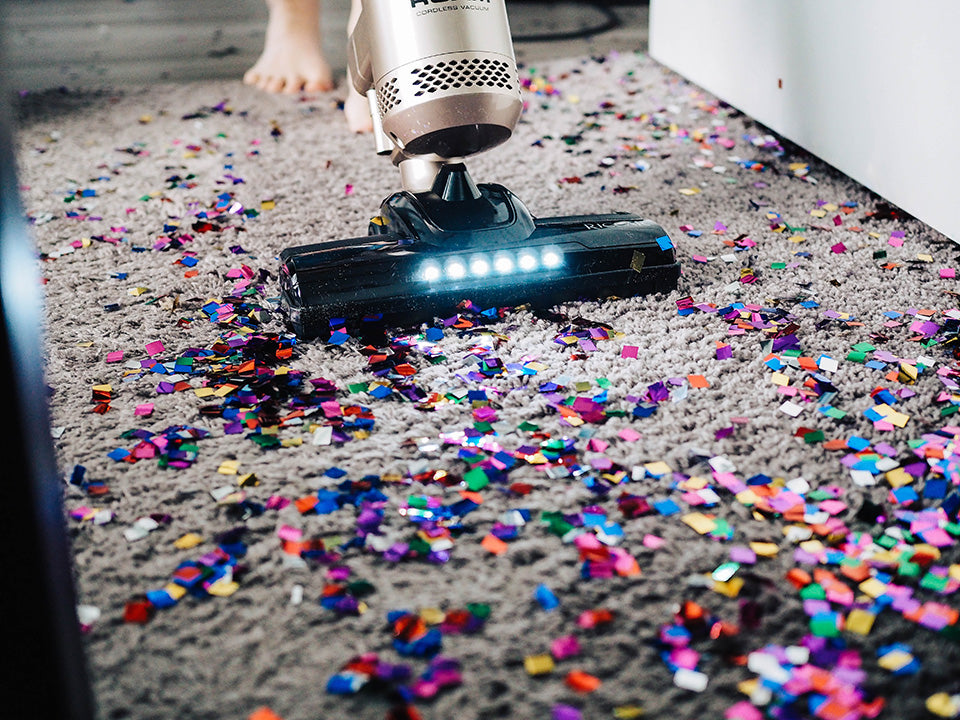 a vacuum cleaning cleaning up sparkled confetti. A reminder that plastic is present in every are of our lives.
