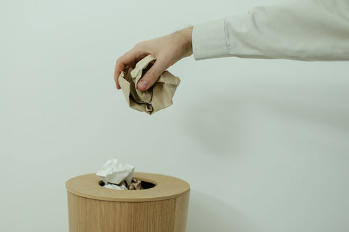  Throwing crumpled paper into trash bin