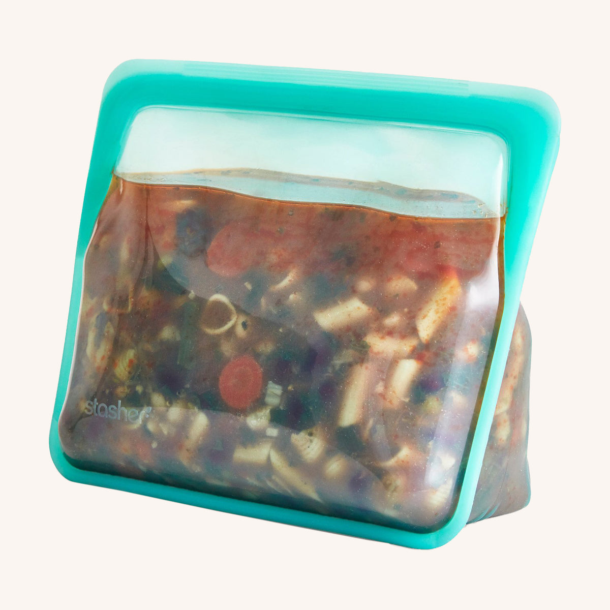 turquoise stasher brand silicone bag filled with soup